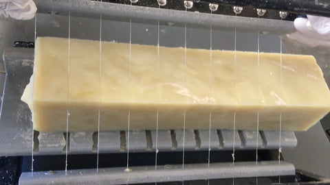 Block of The Mod Cabin soap being cut into to bars with wires.